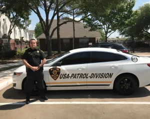 Armed Security Guard Standing Next to Patrol Car in Houston, TX