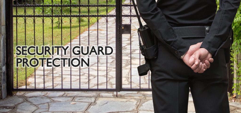 Armed Security Guard Standing by a Gated Entrance