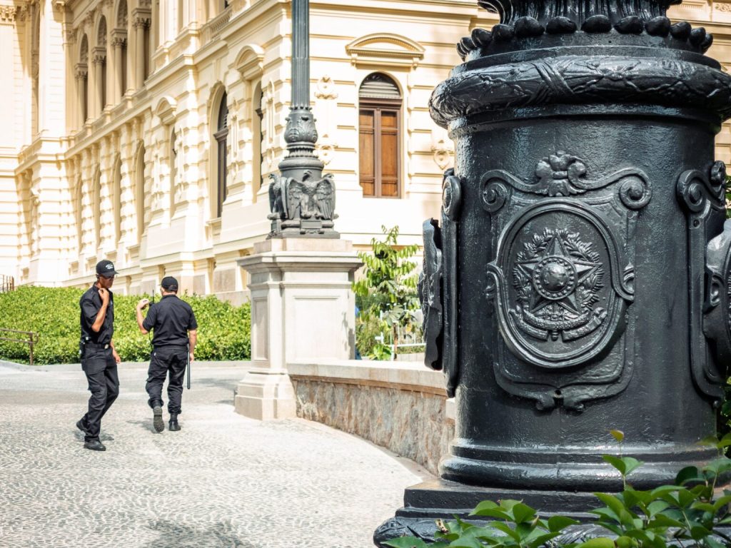 Two security guards patrolling outside a historic building in Houston, TX