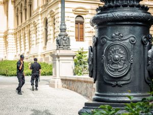 Two security guards patrolling outside a historic building in Houston, TX
